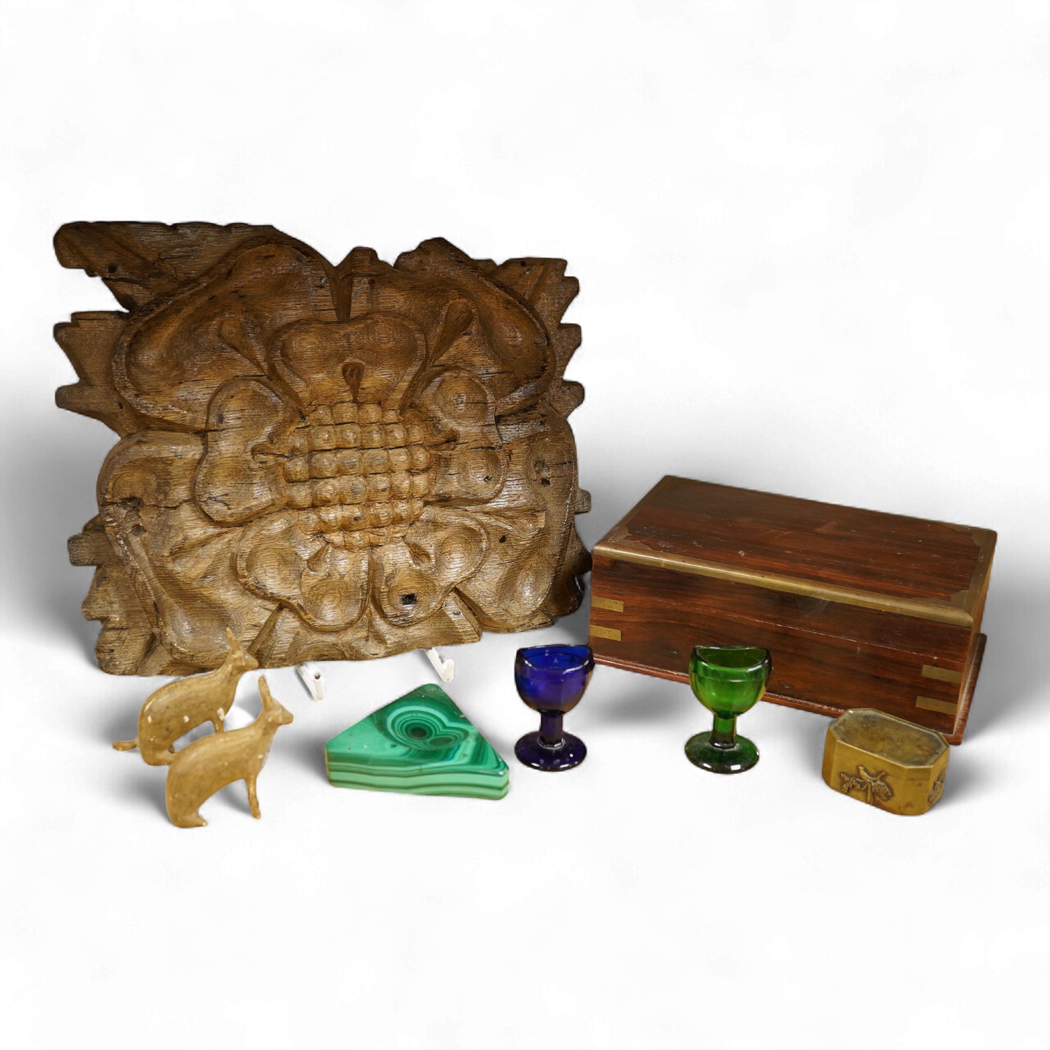 A carving of a Tudor rose-30cm wide, a brass bound box, small brass box, two eye baths, a green malachite ashtray etc